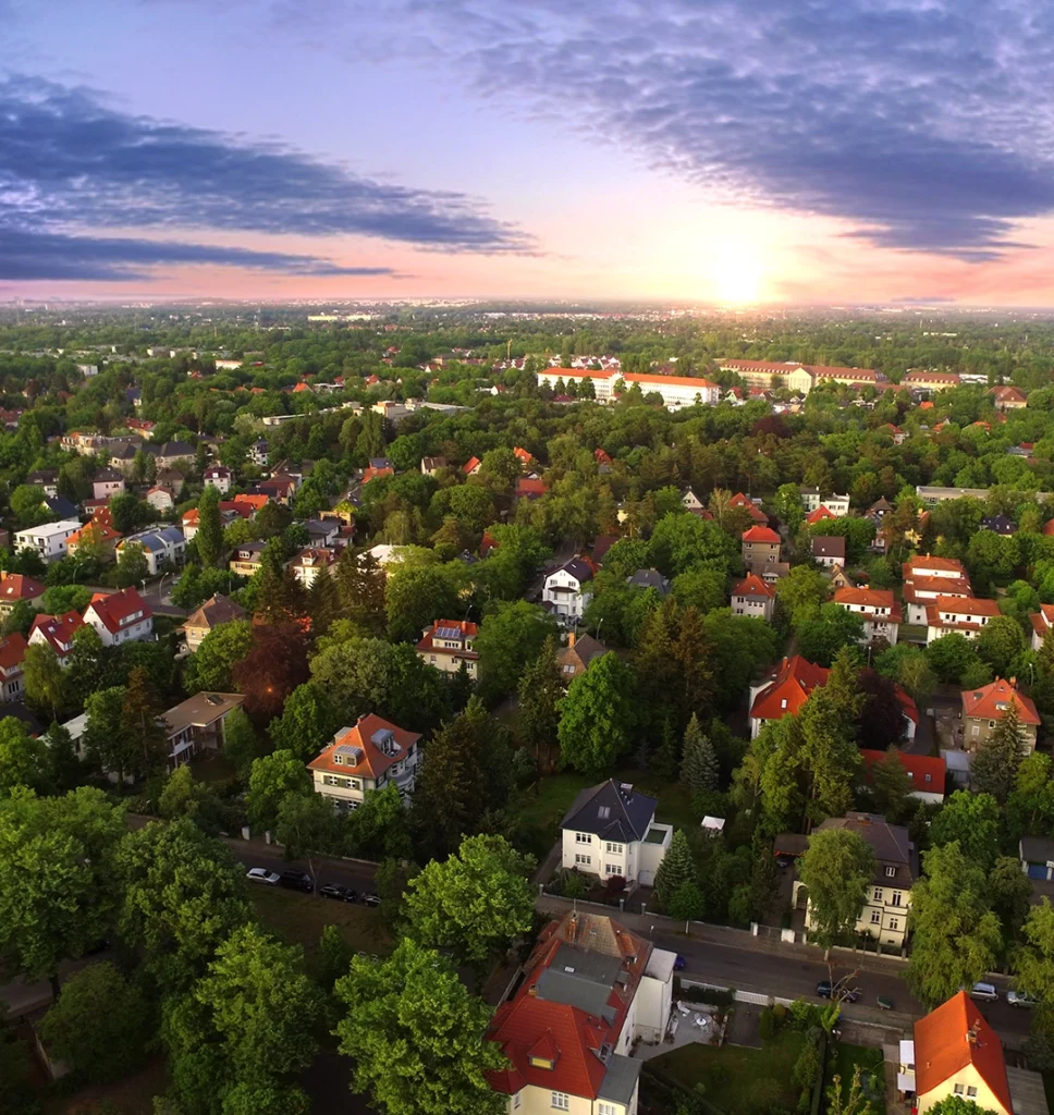 Ein Wohngebiet mit freistehenden Häusern ist aus der Drohnenperspektive zu sehen.